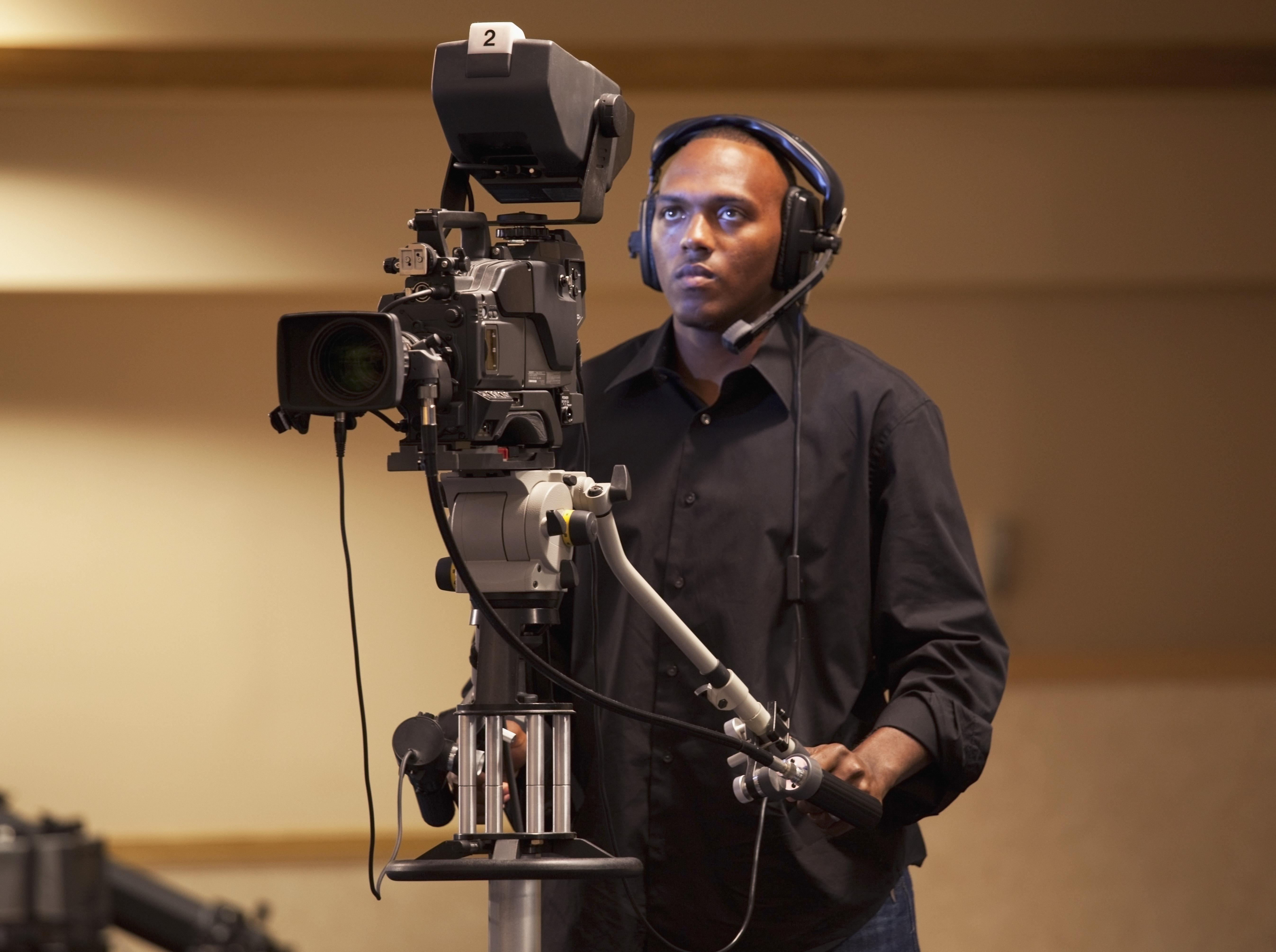A Man Operating A Tv Camera