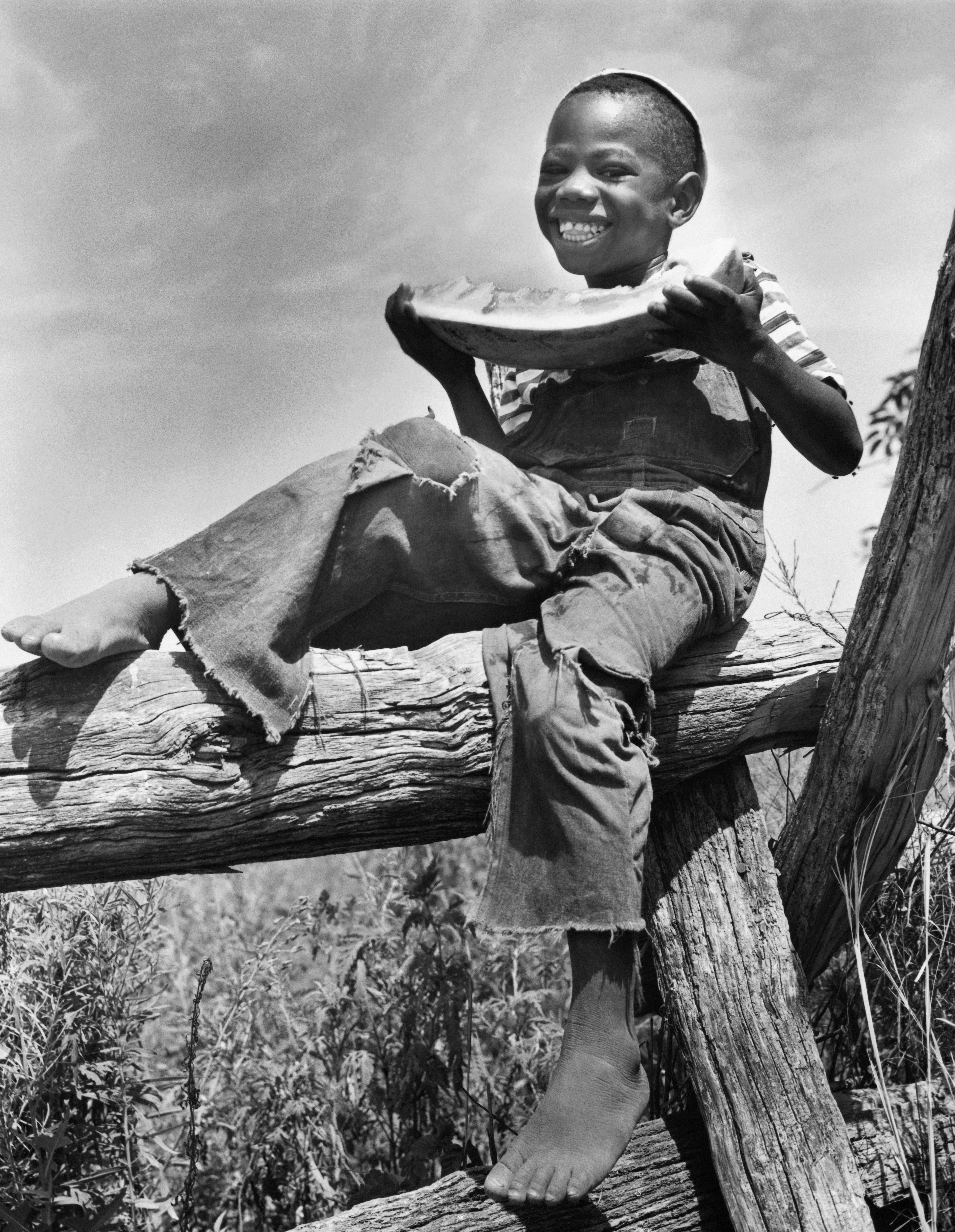 Portrait of a boy holding a slice of watermelon